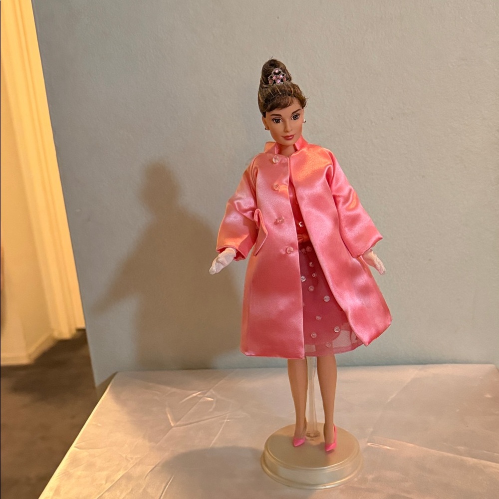Barbie as Audrey Hepburn dressed all in a bright pink ensemble !